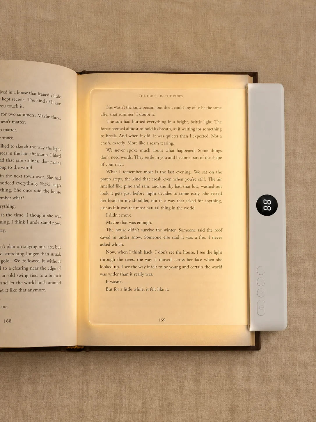 Top view of Lumalli lying flat over and illuminating a book page